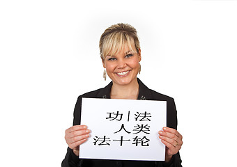 Image showing Studio portrait of a cute blond girl holding a piece of paper