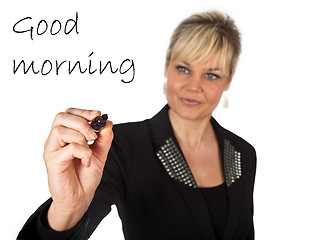 Image showing Studio portrait of a cute blond girl writing on a transparent wa