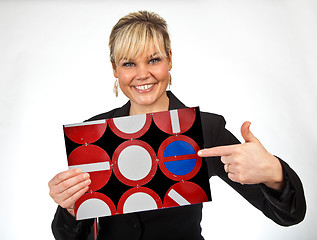 Image showing Studio portrait of a cute blond girl holding a piece of paper