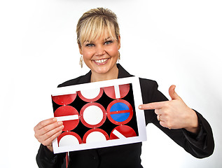 Image showing Studio portrait of a cute blond girl holding a piece of paper