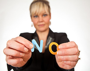 Image showing Studio portrait of a cute blond girl holding two letters forming