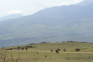 Image showing The group of horsemen in mountains
