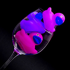 Image showing Pink and purple rubber ducks in wineglasses