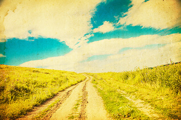 Image showing The road through the field at sunset.