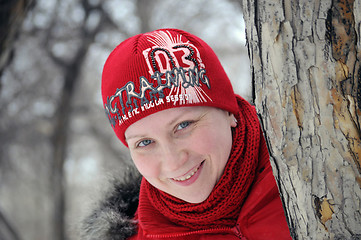 Image showing The woman's portrait in a red jacket and a red cap