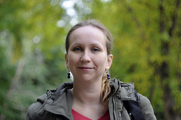 Image showing Portrait of the beautiful woman against autumn leaves.