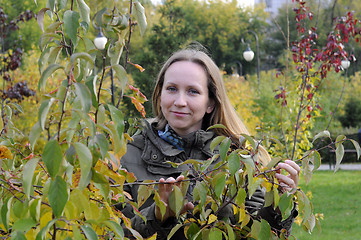 Image showing Portrait of the beautiful woman against autumn leaves.