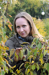 Image showing Portrait of the beautiful woman against autumn leaves.