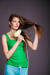 Image showing Woman with hair dryer