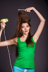 Image showing Woman with hair dryer