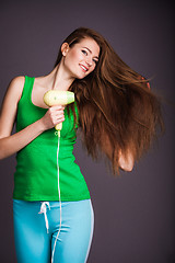 Image showing Woman with hair dryer
