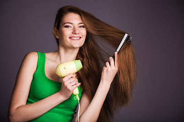 Image showing Woman with hair dryer