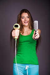 Image showing Woman with hair dryer