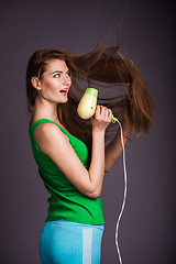 Image showing Woman with hair dryer