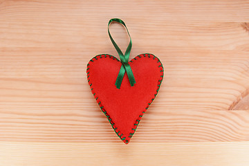 Image showing Red felt heart ornament with green ribbon