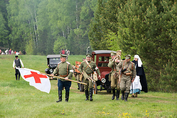 Image showing Unidentified men with medicine red cross flag