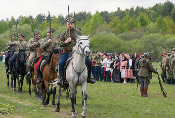 Image showing Cavalry soldiers ride on horses with naked swords