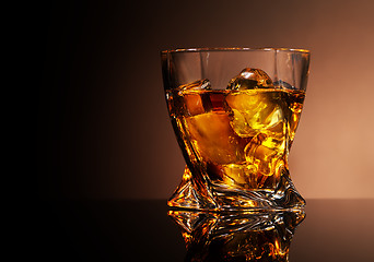 Image showing Glass of golden brandy