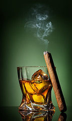 Image showing Whiskey and cigar on green