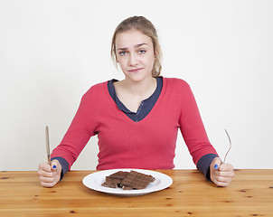 Image showing girl with plate full of chocolate