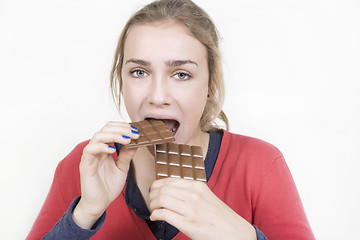 Image showing girl eats lots of chocolate