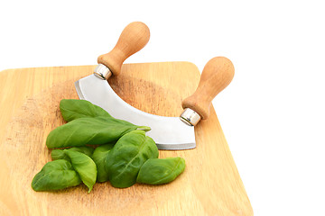 Image showing Fresh basil leaves with a rocking knife