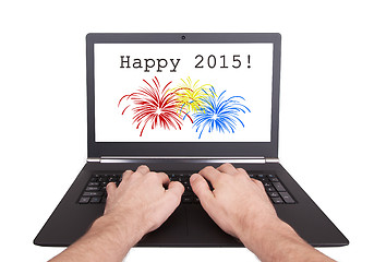 Image showing Man working on laptop, happy 2015