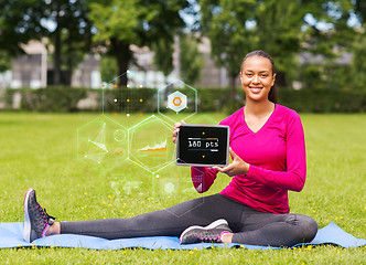 Image showing smiling woman with tablet pc outdoors