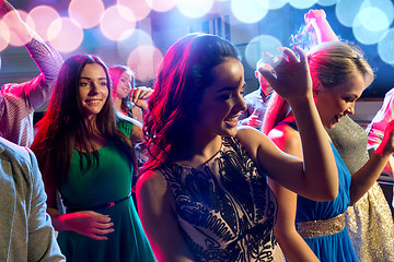 Image showing smiling friends dancing in club