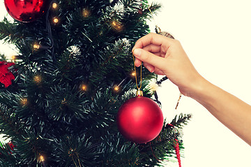 Image showing close up of woman with christmas tree decoration