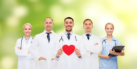 Image showing group of smiling doctors with red heart shape