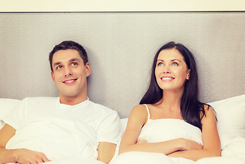 Image showing happy couple dreaming in bed