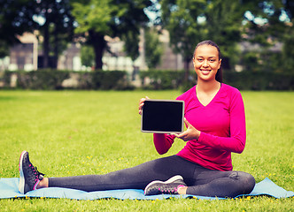 Image showing smiling woman with tablet pc outdoors