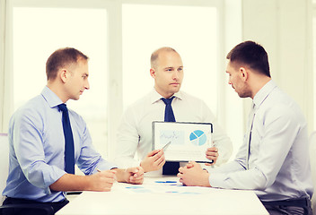 Image showing serious businessmen with papers in office