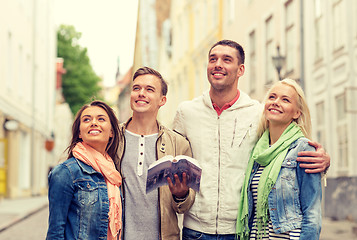 Image showing group of friends with city guide exploring town