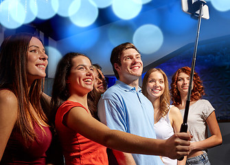 Image showing friends with smartphone taking selfie in club