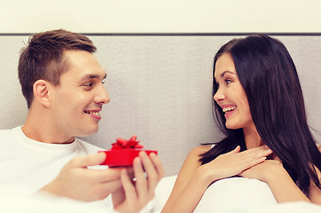 Image showing man giving woman little red gift box