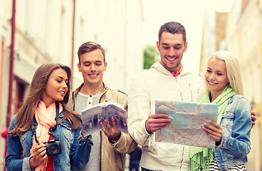 Image showing group of friends with city guide, map and camera