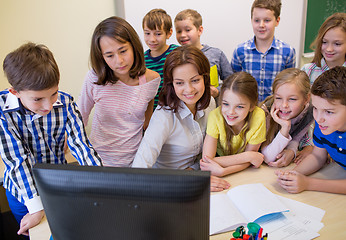 Image showing group of kids with teacher and computer at school