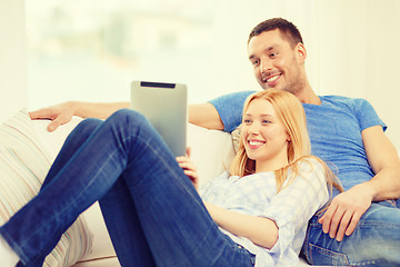 Image showing smiling happy couple with tablet pc at home