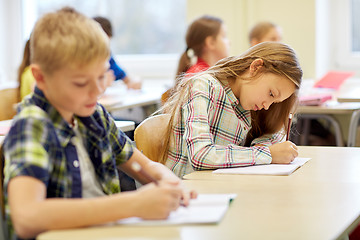 Image showing group of school kids writing test in classroom