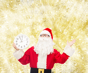 Image showing man in costume of santa claus with clock