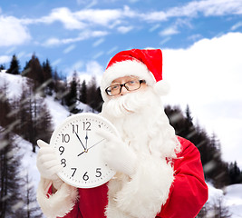 Image showing man in costume of santa claus with clock