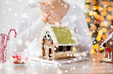 Image showing close up of woman making gingerbread houses