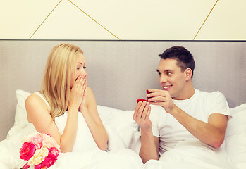 Image showing man giving woman little red box and ring in it