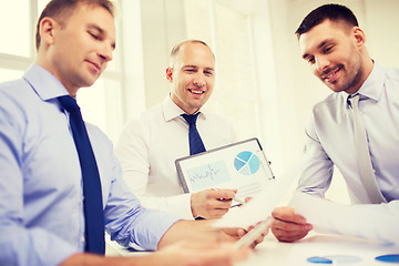 Image showing smiling businessmen with papers in office