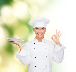 Image showing female chef with plate showing ok sign