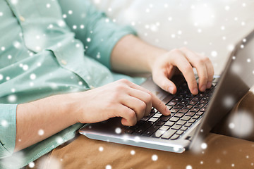 Image showing close up of man working with laptop at home