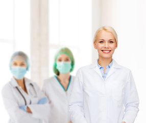 Image showing smiling female doctor with group of medics