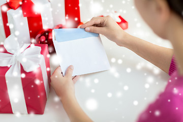 Image showing close up of woman with letter and presents